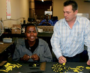 Webb Industries kitting division manager, Mark Colling, with co-worker Barbara Mzizi